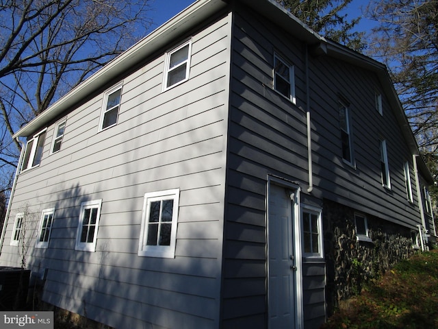 view of side of home featuring central air condition unit