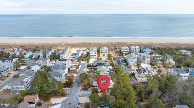 drone / aerial view featuring a water view and a view of the beach