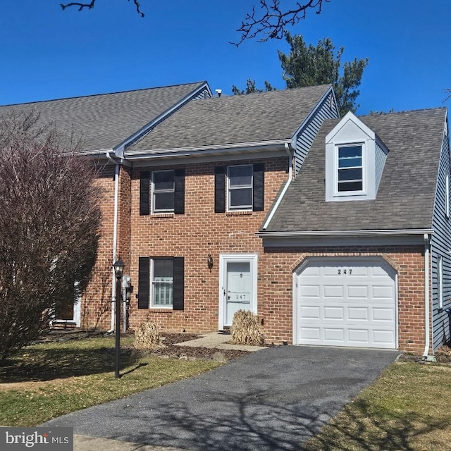 view of front of house with aphalt driveway, a garage, brick siding, and a shingled roof