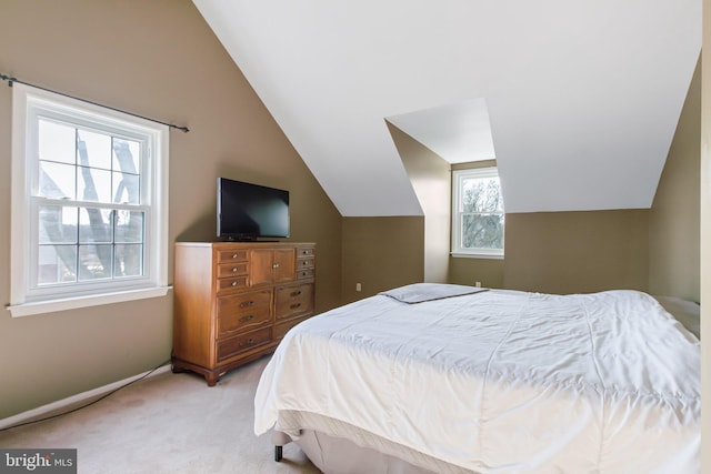 bedroom featuring lofted ceiling and light colored carpet