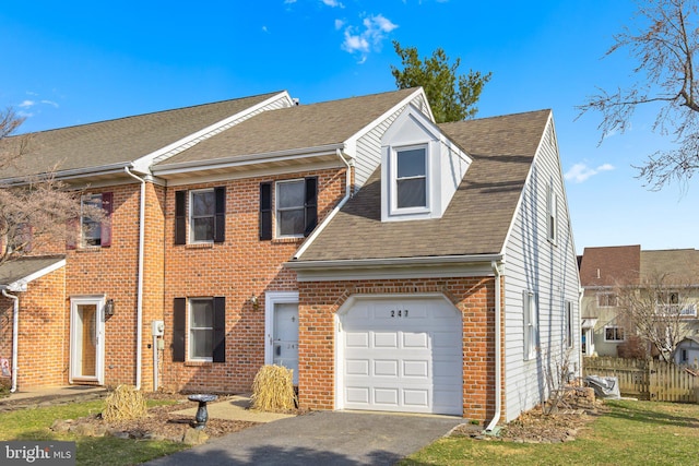 view of front of house with fence, an attached garage, a shingled roof, aphalt driveway, and brick siding