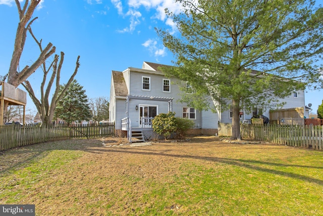 back of house featuring a yard, a pergola, and a fenced backyard