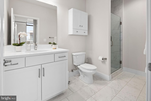 bathroom with vanity, toilet, and a shower with shower door