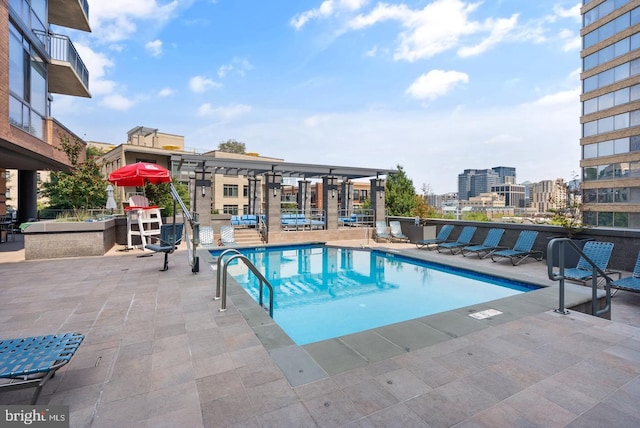 view of pool with a pergola and a patio