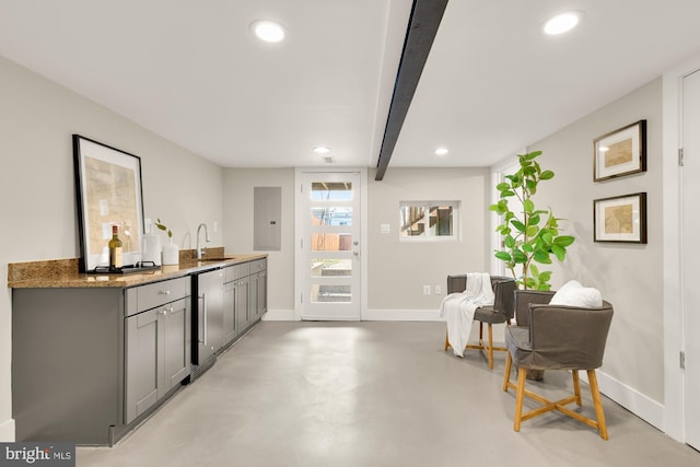 interior space with finished concrete floors, baseboards, indoor wet bar, and recessed lighting