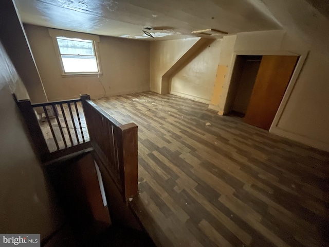 bonus room with dark hardwood / wood-style floors