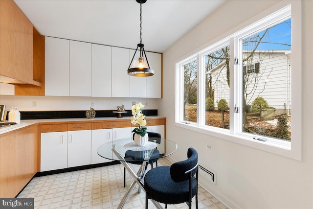 kitchen featuring pendant lighting and white cabinets