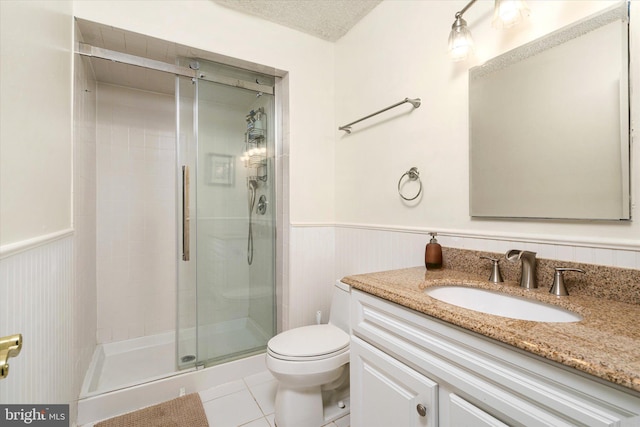 bathroom with tile patterned flooring, vanity, an enclosed shower, toilet, and a textured ceiling