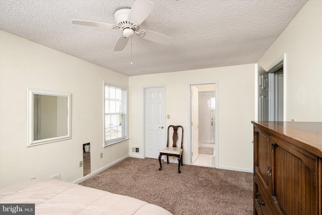 bedroom with connected bathroom, a textured ceiling, and carpet flooring