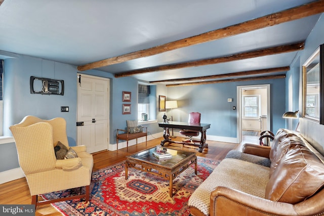 living room with beamed ceiling and hardwood / wood-style floors