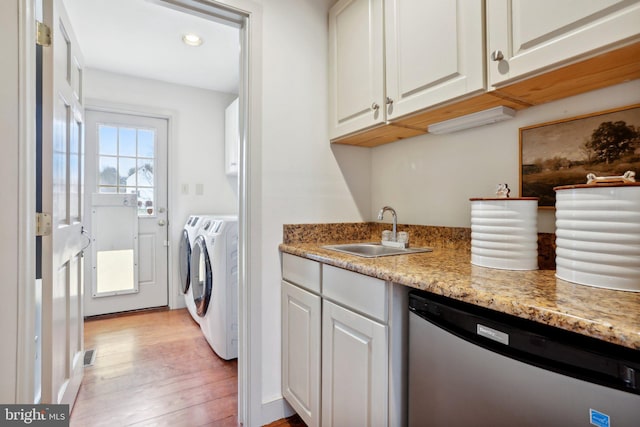 kitchen with sink, dishwasher, light stone countertops, washer and dryer, and white cabinets