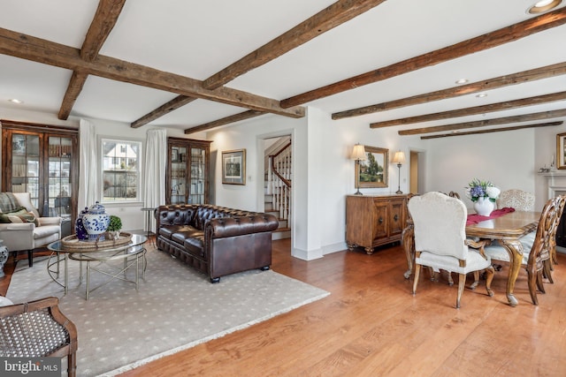 living room featuring hardwood / wood-style flooring and beamed ceiling