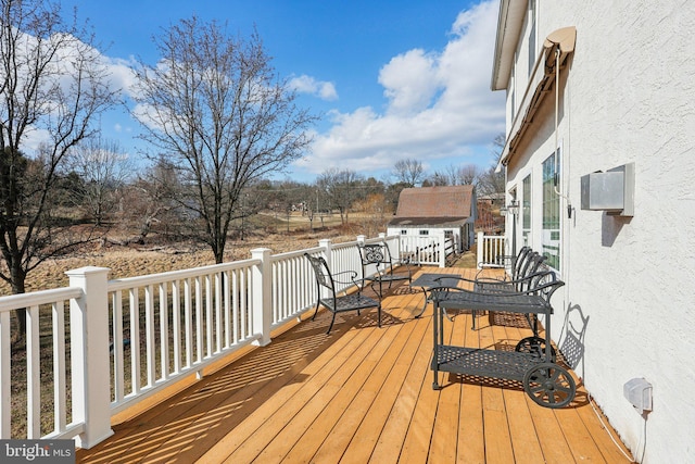 wooden terrace with a shed