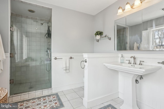 bathroom with tile patterned flooring and walk in shower