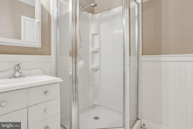 bathroom featuring vanity and a shower with shower door