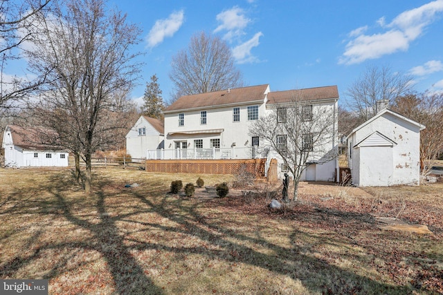 back of house with a yard and a deck