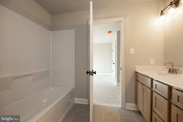 bathroom featuring tile patterned flooring, vanity, and baseboards