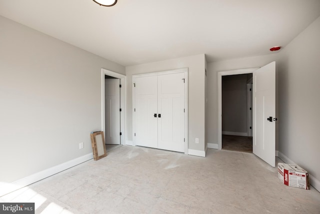 unfurnished bedroom featuring a closet and baseboards