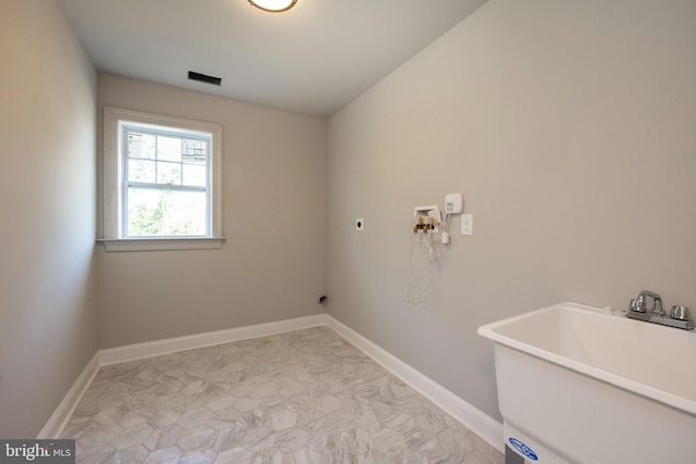 washroom featuring hookup for a washing machine, hookup for an electric dryer, laundry area, a sink, and visible vents