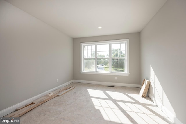 unfurnished room with visible vents and baseboards