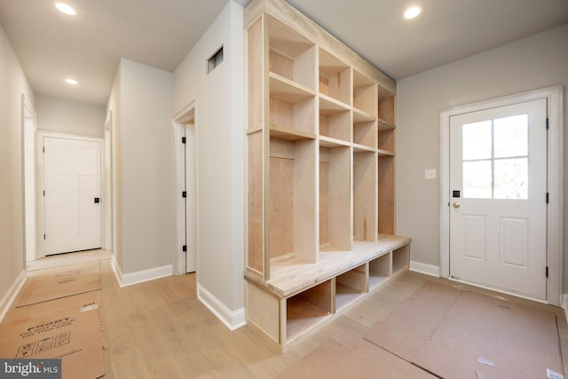 mudroom featuring baseboards, light wood finished floors, and recessed lighting