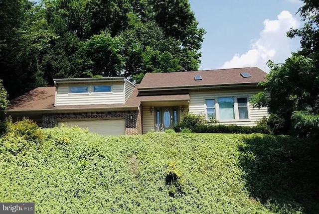 view of front facade with brick siding and driveway