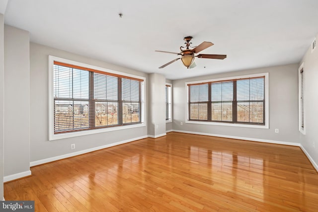 unfurnished living room with visible vents, a ceiling fan, light wood-style flooring, and baseboards