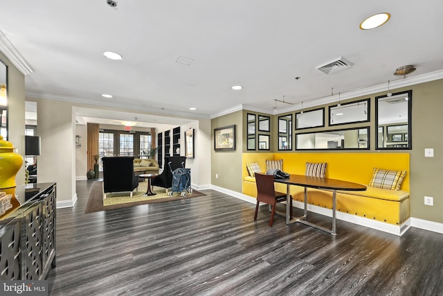 dining space with ornamental molding, visible vents, and dark wood-style floors