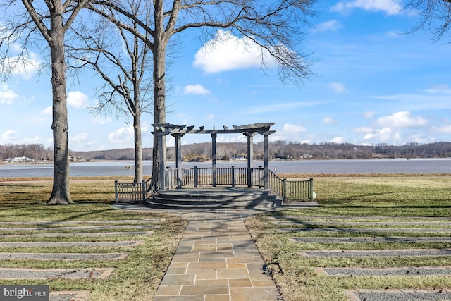 view of community featuring a water view and a yard