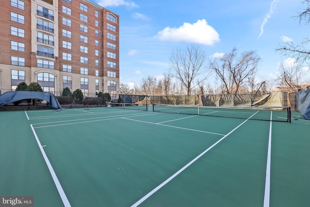 view of tennis court featuring fence