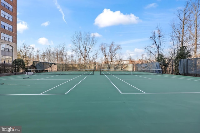 view of sport court featuring fence