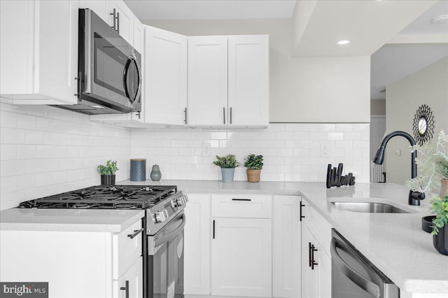 kitchen with white cabinetry, appliances with stainless steel finishes, and sink