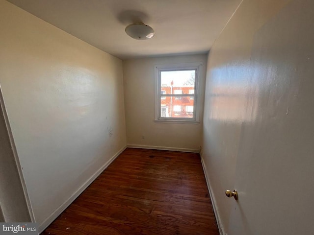 unfurnished room with dark hardwood / wood-style flooring