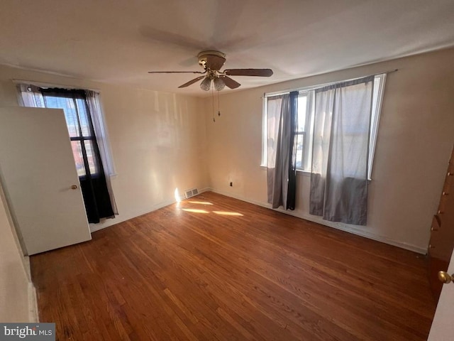 unfurnished room with hardwood / wood-style floors and ceiling fan