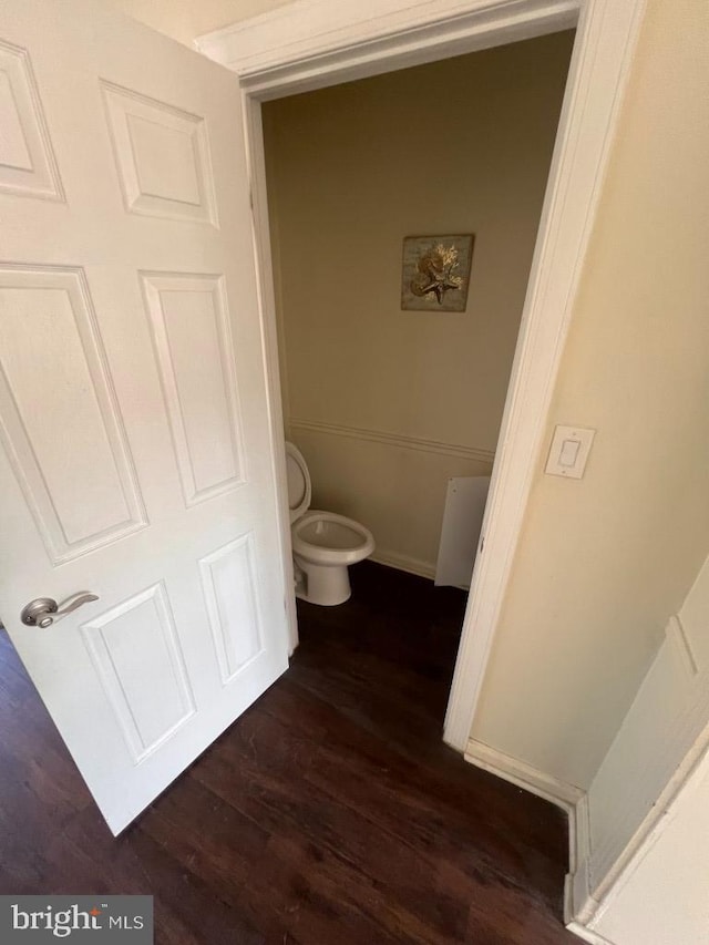 bathroom featuring hardwood / wood-style floors and toilet