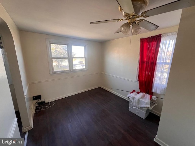 spare room with dark hardwood / wood-style flooring and ceiling fan