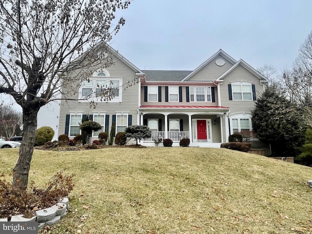 view of front of home featuring covered porch and a front lawn