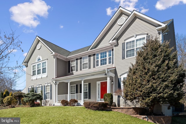 view of front of property with a porch and a front lawn