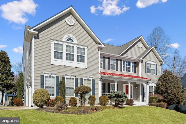 view of front of house with a front yard and covered porch