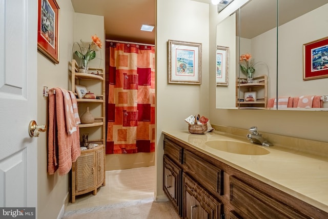 bathroom featuring curtained shower, vanity, and tile patterned floors