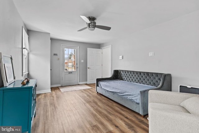 living room featuring dark wood-type flooring and ceiling fan