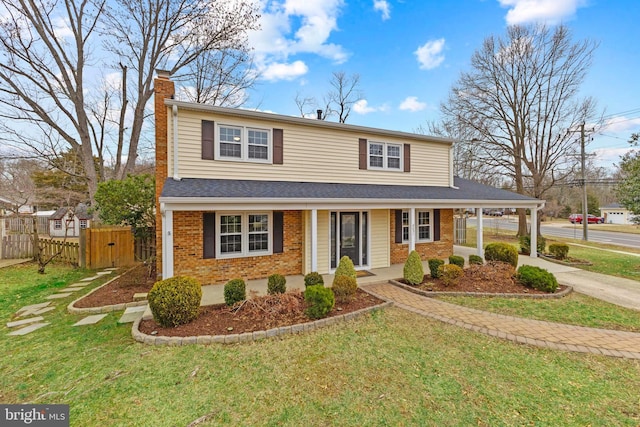 view of property with covered porch and a front yard