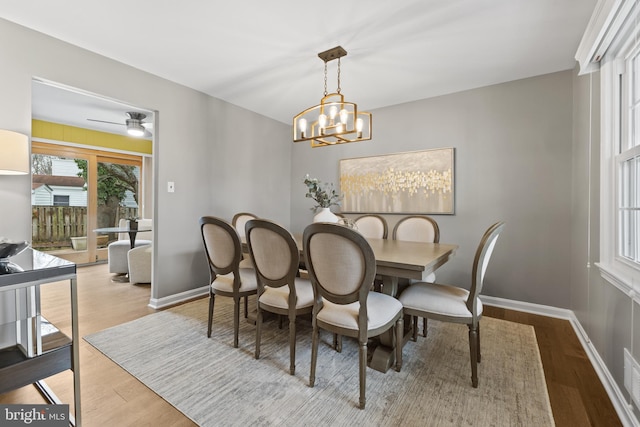 dining space with an inviting chandelier and light wood-type flooring