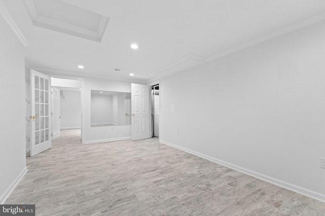 empty room featuring ornamental molding and light wood-type flooring