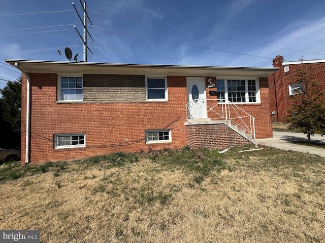 single story home with brick siding and a front lawn