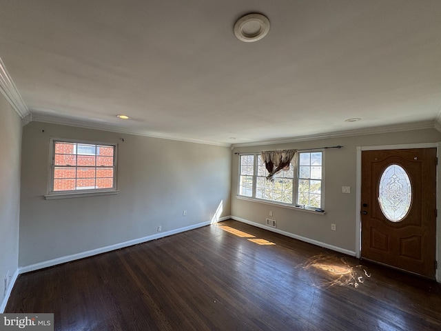 foyer entrance with visible vents, crown molding, dark wood-type flooring, and baseboards