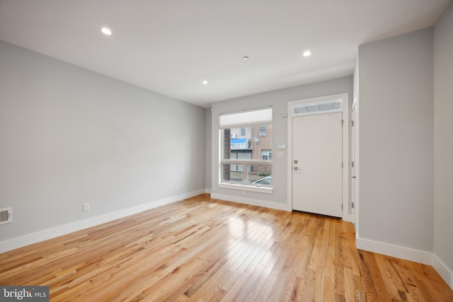 foyer entrance with light hardwood / wood-style floors