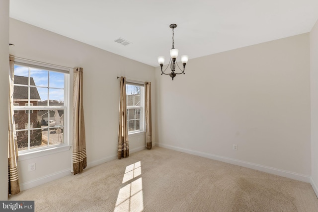 unfurnished dining area with a chandelier, light carpet, and a wealth of natural light