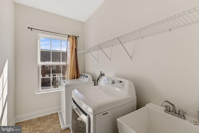 clothes washing area featuring sink and independent washer and dryer