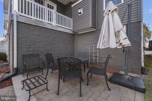 view of patio featuring a balcony